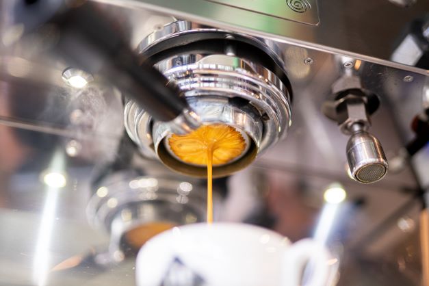 Pressure pushes an espresso shot through a naked portafilter at 19grams